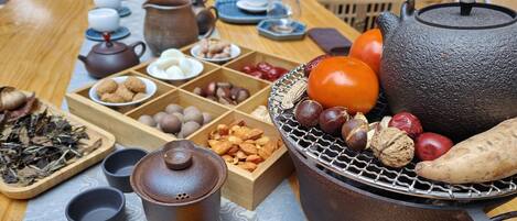A traditional tea setting with various tea utensils and snacks.
