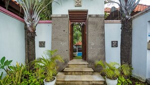 A pathway leading to a building entrance with steps and potted plants on either side. - 7BR-Last Minute Deal 50%+ OFF!! Nusa Dua (Bali)