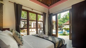 A bedroom with a large bed, a view of the garden, and a pool. - 7BR-Last Minute Deal 50%+ OFF!! Nusa Dua (Bali)