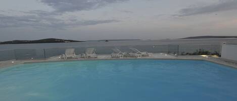 Una piscina al aire libre, una piscina climatizada