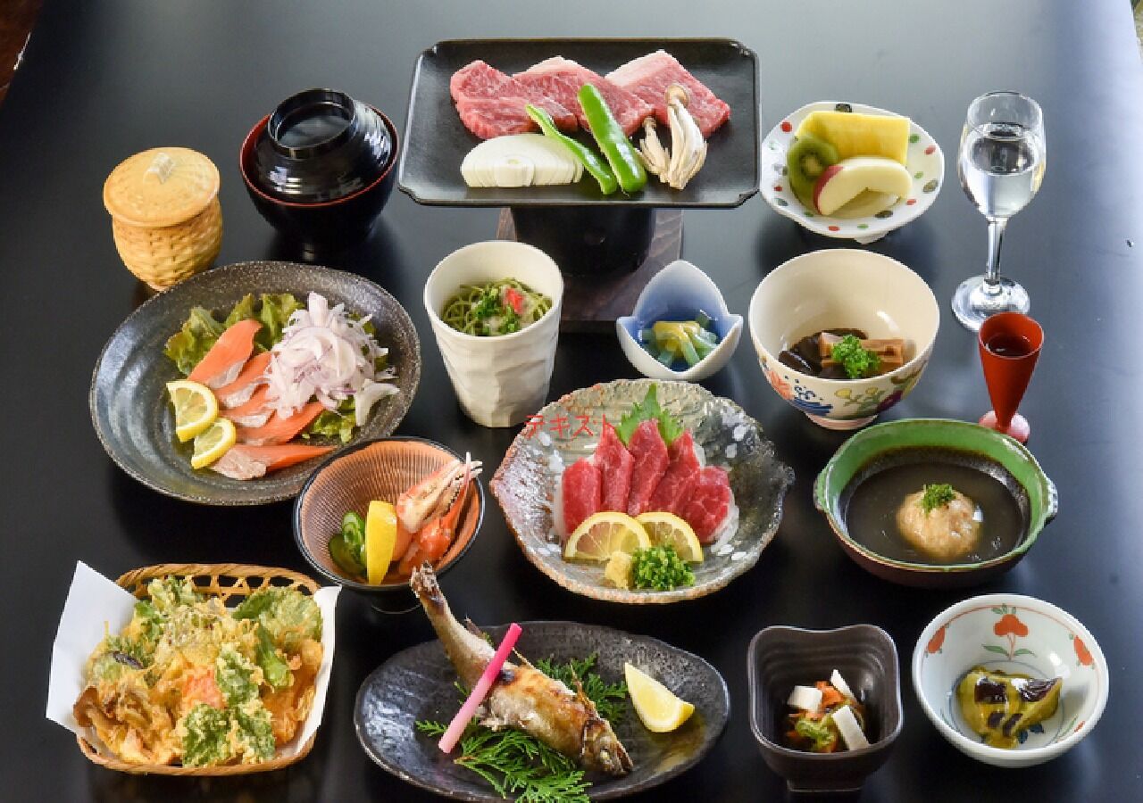 A variety of dishes and a glass of water on a table.