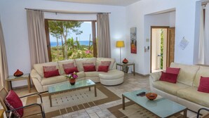 A living room with a sofa set, a coffee table, and a view of the outdoors. - Superb Villa in Coral Bay Paphos, with Half Cost of the HEATED POOL Nov-Mar 26 (Paphos (Pafos))