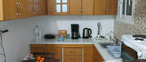 Fridge, coffee/tea maker, electric kettle, cookware/dishes/utensils