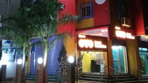 A multi-story building with a prominent 'OYO' sign on the facade. - Hotel Radiation (Deoghar)
