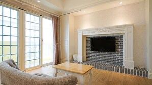 A modern living room with a fireplace, a large window with curtains, and a wooden table. - Good Time (Magong)