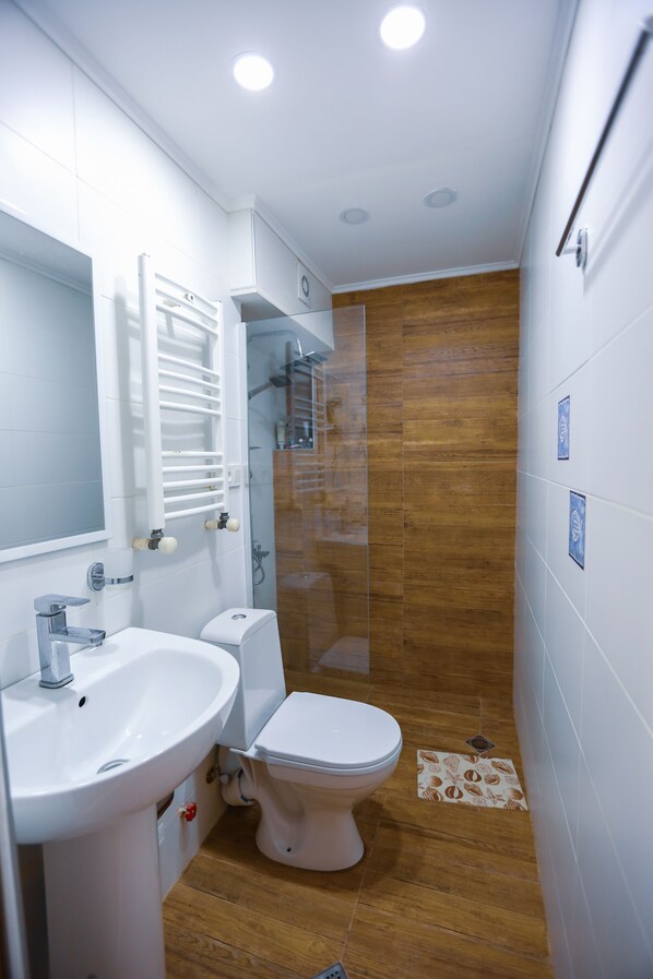 Apartment, 1 Bedroom | Bathroom | Shower, free toiletries, hair dryer, slippers