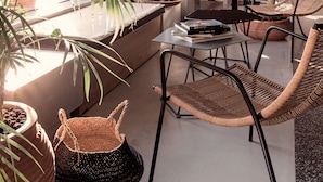 A modern interior with a dining area, wicker furniture, and potted plants. - More Meni City Beach Rhodes (Rhodes)