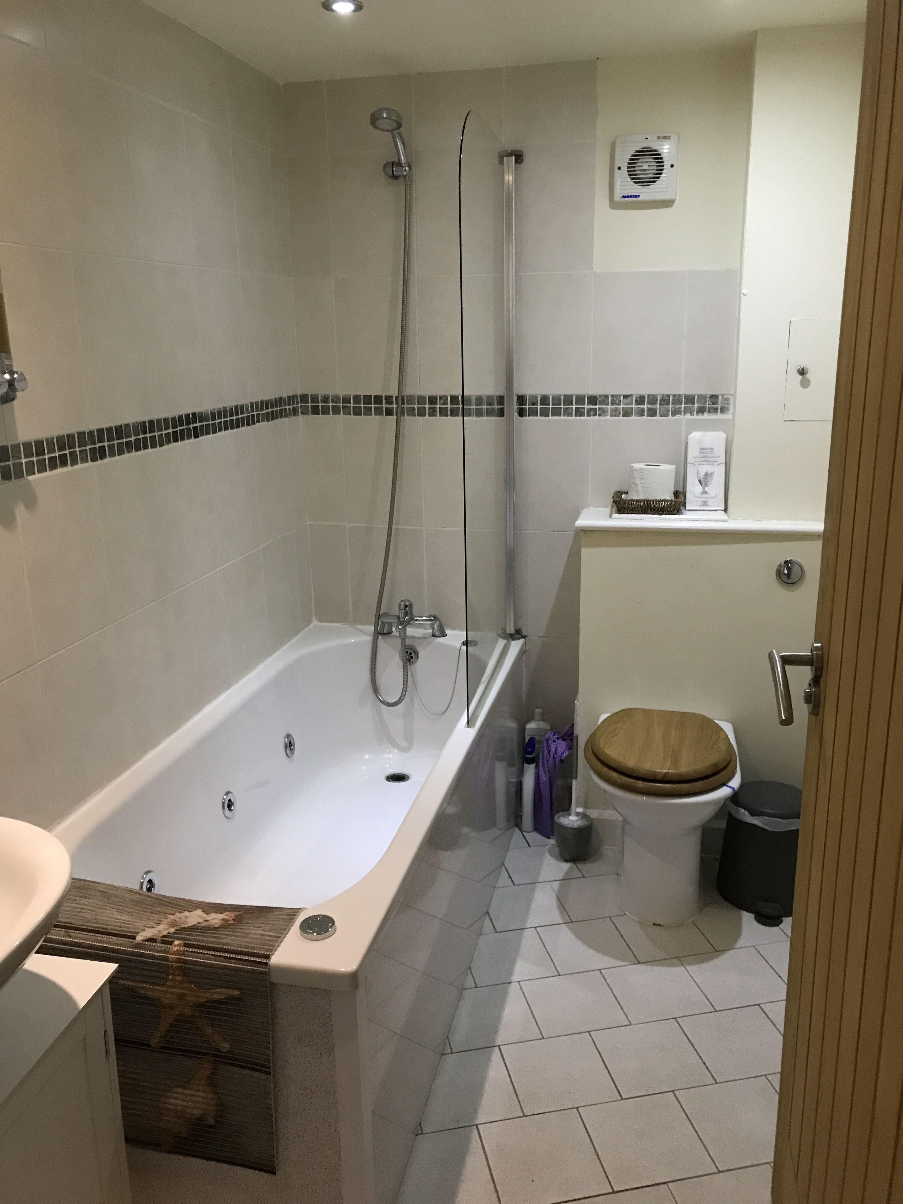 A bathroom with a bathtub, a shower, a toilet, and a sink.