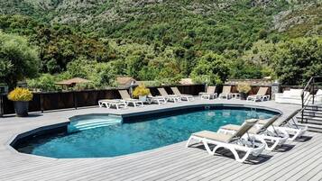 Seasonal outdoor pool, pool umbrellas, pool loungers