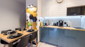 A modern kitchen with a built-in microwave, a coffee maker, and a sink. - Izerska Przygoda - Apartamenty 5d (Swieradow-Zdroj)