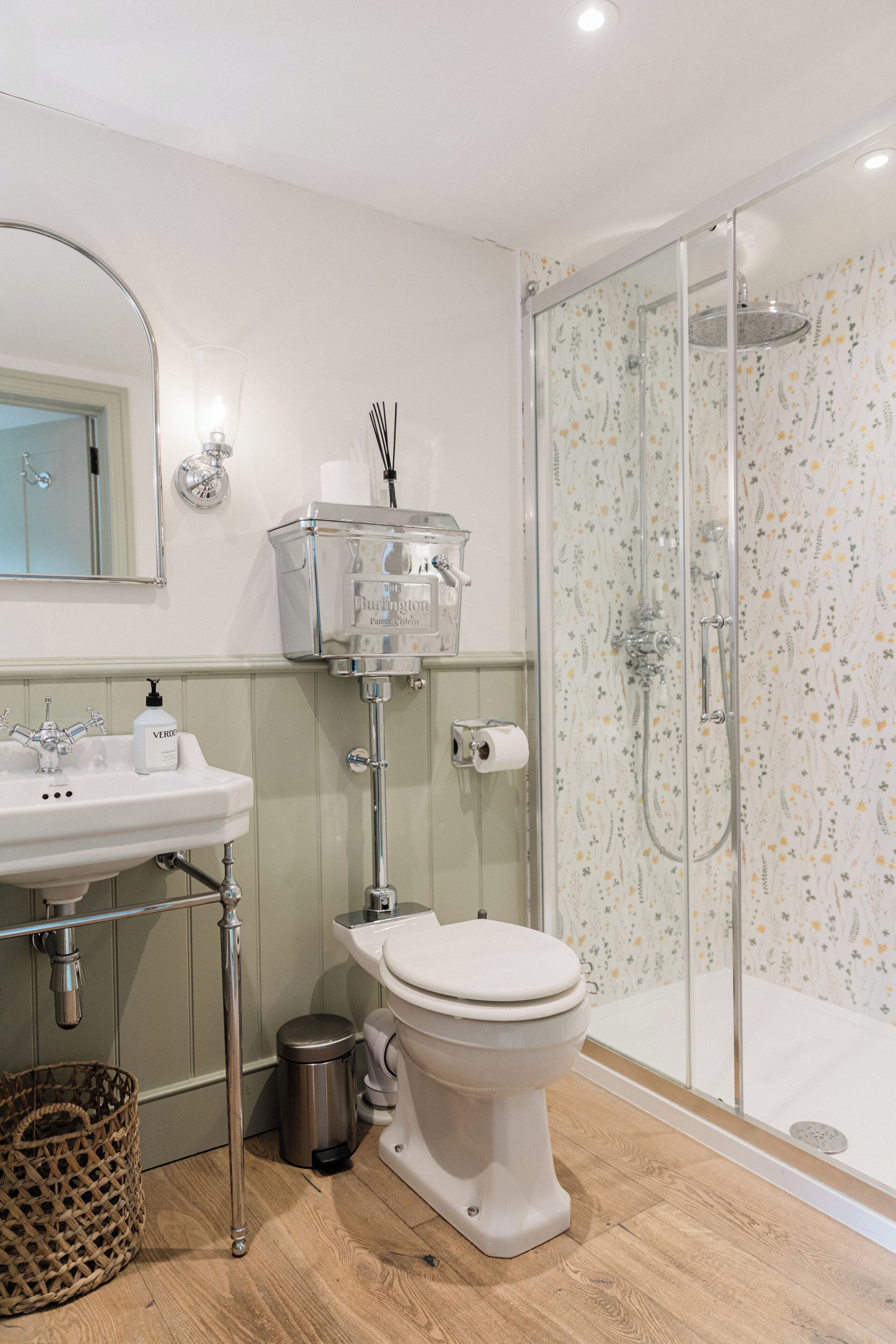 A modern bathroom with a toilet, sink, and shower.