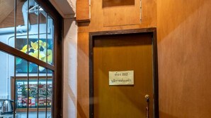 A wooden door with a sign indicating room number 200. - Sip N' Camp - Hostel (Bangkok)