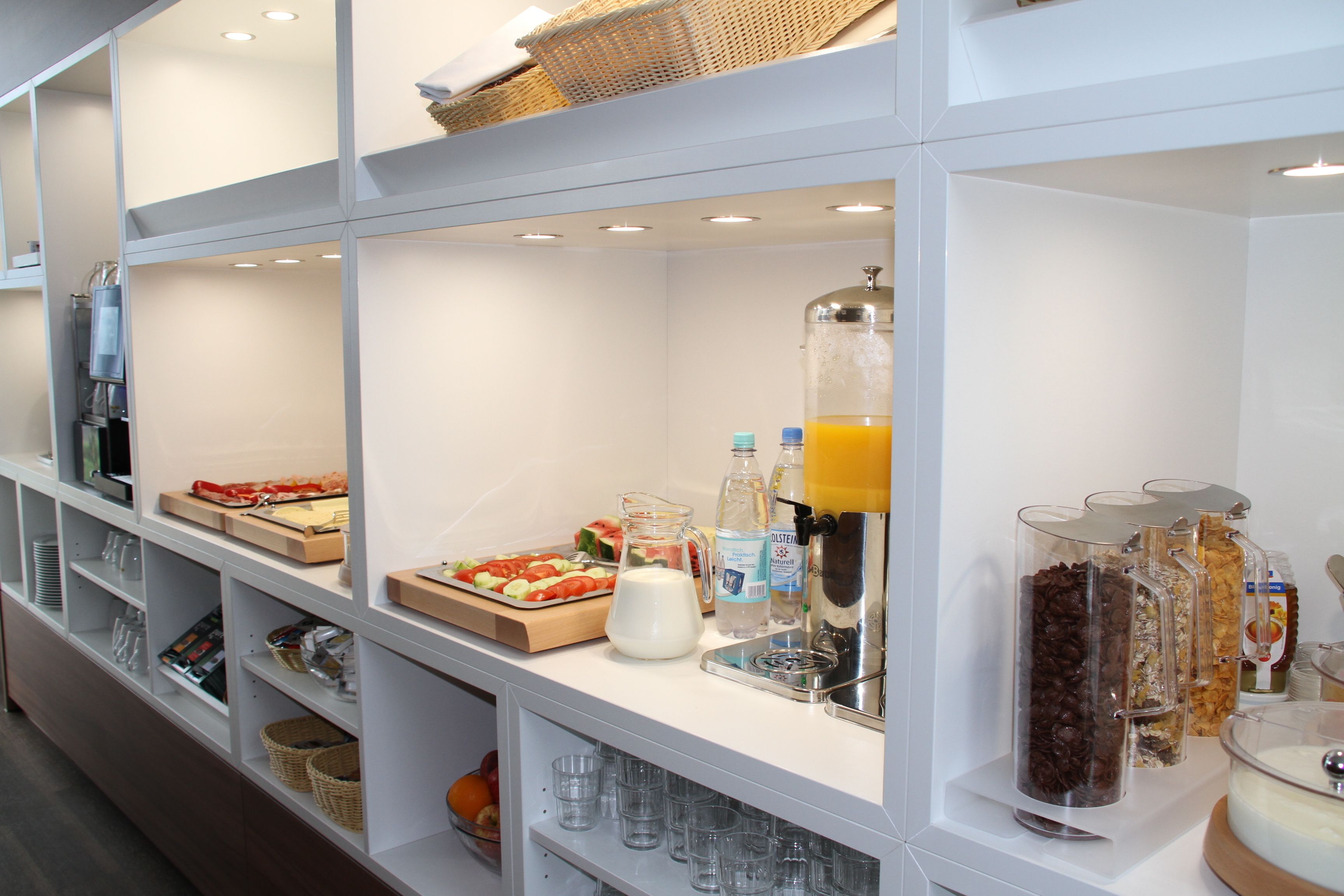 A breakfast bar with various food items and beverages.
