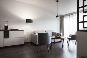 Deluxe Suite | Living area | 80-cm flat-screen TV with cable channels, TV, heated floors