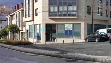A building with a sign for 'The Credencial Alberque Hotel Hostel' indicating it is a hostel.