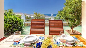 A table set for two with a view of the sea.
