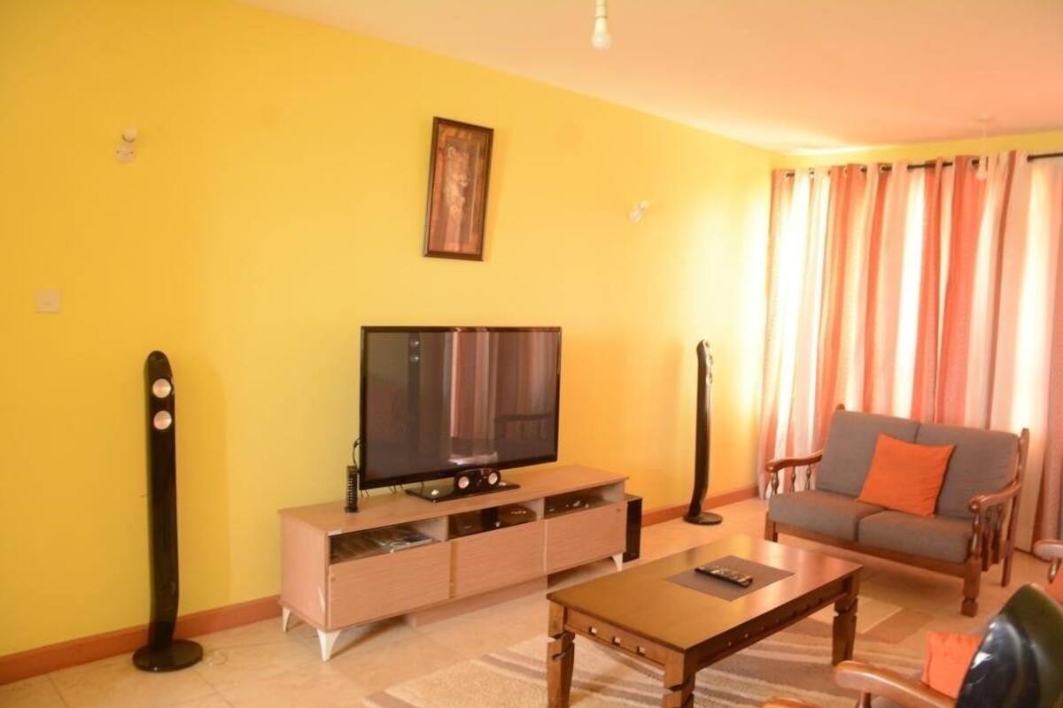 comfort apartment, multiple beds, non smoking | living area | 42-inch flat-screen tv with satellite channels, tv