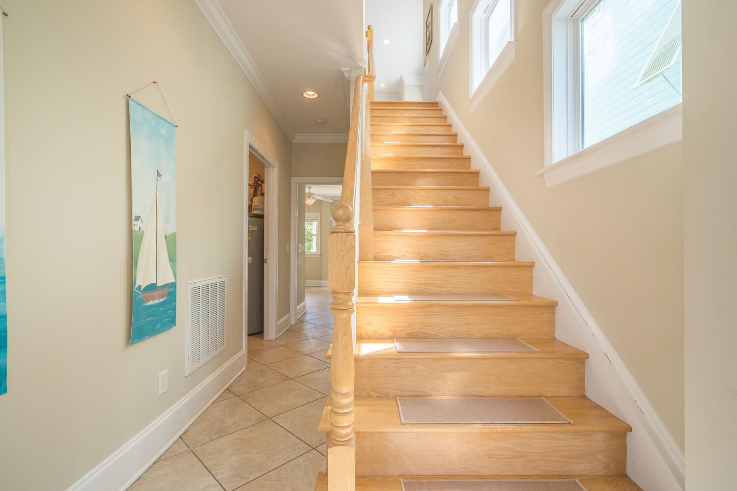 A wooden staircase with a handrail, leading to an upper floor.