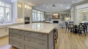 A spacious kitchen with a large island, built-in appliances, and ample natural light from large windows. - 13 Duck Hawk -Relax on the Front porch w/ rockers and a private pool! (Hilton Head Island)
