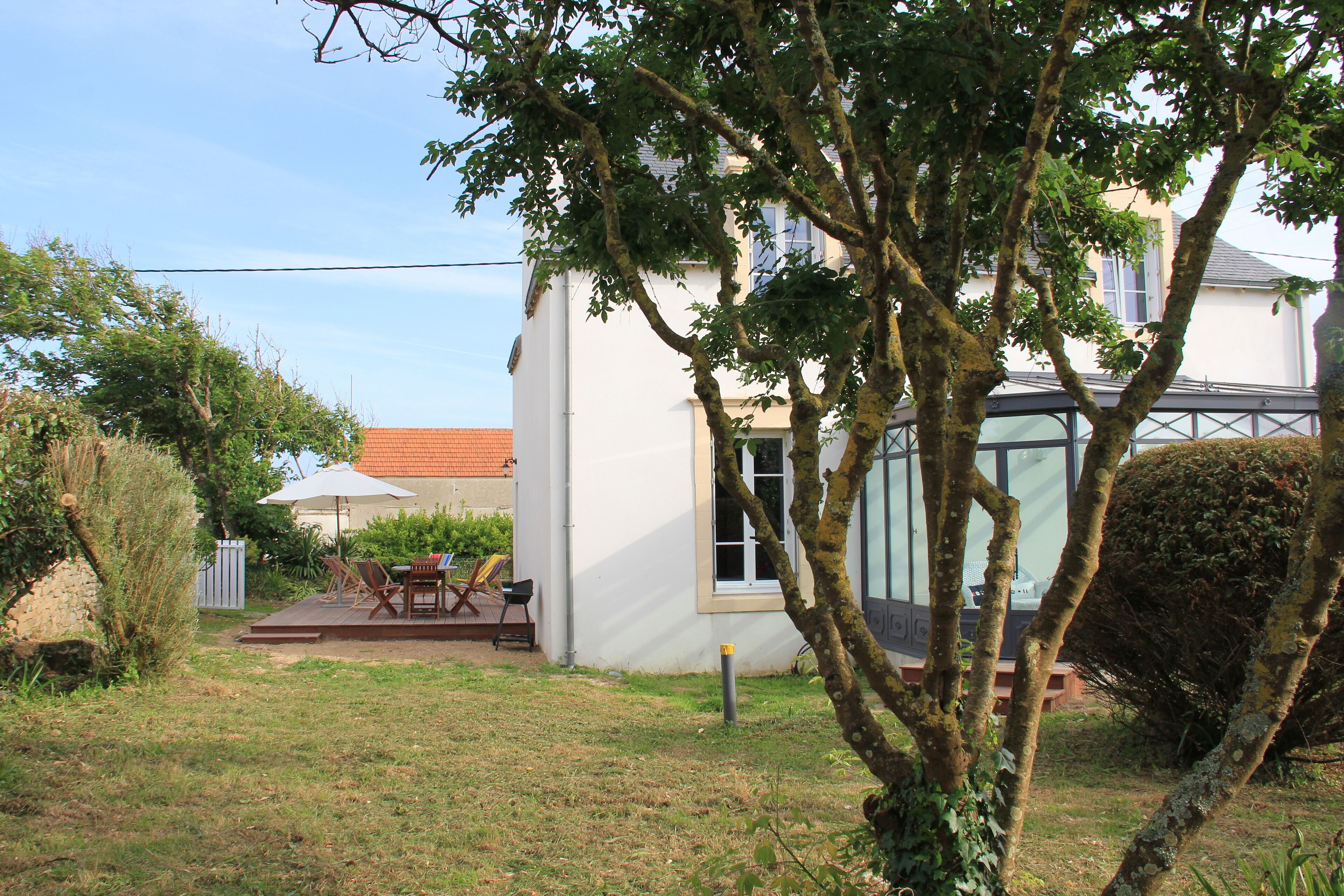A house with a patio, a table, and chairs.