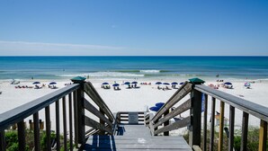 A wooden boardwalk leading to a beach with umbrellas and beach chairs. - Stay directly on 30A! Beautiful Beach House with private courtyard and panoramic views! Short walks to beach, pool, Rosemary and Alys! (Panama City Beach)