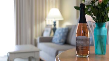 A bottle of Chateau Chantal wine on a table with a vase of flowers.