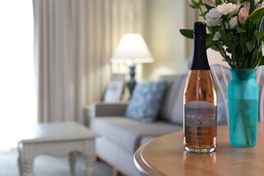 En flaske Chateau Chantal sekt på et bord med en vase blomster.