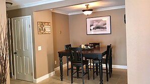 A dining area with a table and chairs, a ceiling light, and a framed picture on the wall. - Great NON-SMOKING, NO PETS ALLOWED..Easy to Get to, Short Drive To San Diego Fun (Bonita)