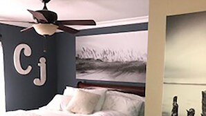 A bedroom with a bed, a ceiling fan, a painting, and a wall-mounted letter 'Cj'. - Great NON-SMOKING, NO PETS ALLOWED..Easy to Get to, Short Drive To San Diego Fun (Bonita)