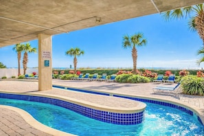 A pool area with a clear view of the ocean, lounge chairs, and a sign prohibiting diving. - North Shore Villas 801 (North Myrtle Beach)