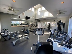 A gym with exercise equipment, a mirror, and large windows. - Poolside Resort Style Awesomeness (Phoenix)