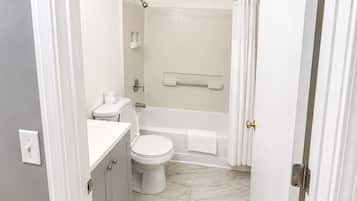 A bathroom with a toilet, sink, and bathtub.