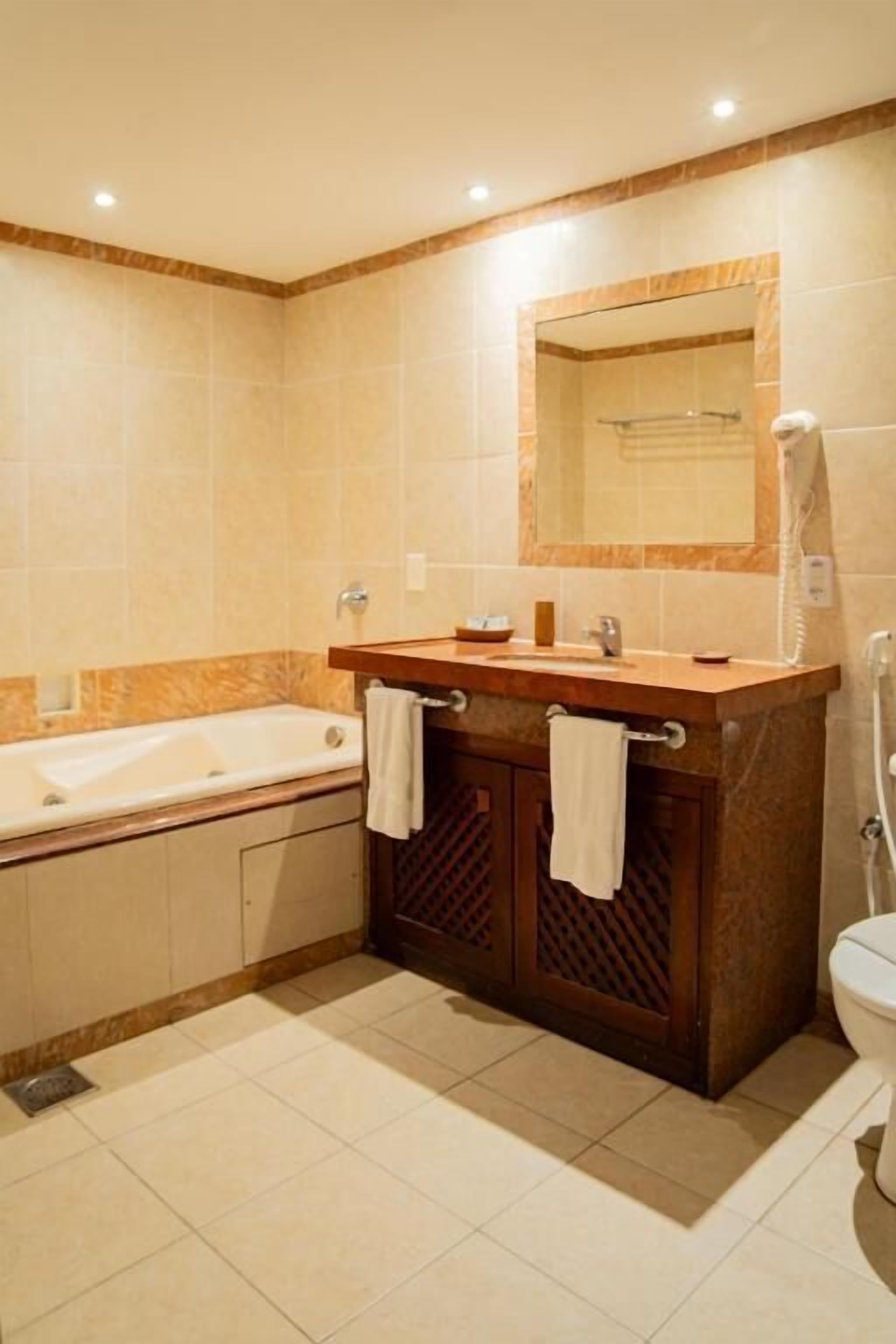 master suite with jacuzzi | bathroom | shower, rainfall showerhead, free toiletries, hair dryer