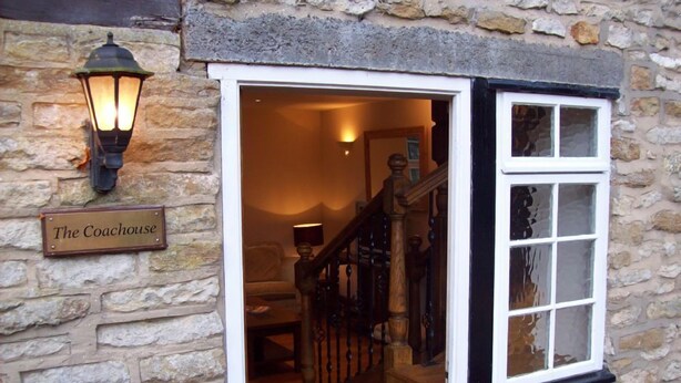 A stone building with a sign reading "The Coachhouse." - The Coachhouse (Scarborough)