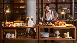 A restaurant counter with a variety of food items, a waiter, and a wooden interior. - Ecrin Blanc Resort Courchevel (Courchevel)
