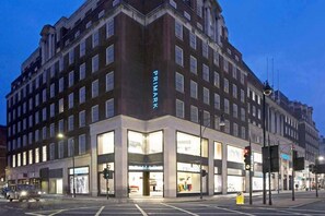 A multi-story building with a prominent 'PRIMARK' sign on the corner.