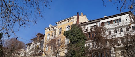 A historic building with multiple stories, large windows, and a mix of architectural styles.
