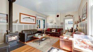 A cozy living room with a fireplace, leather sofas, and a dining area. - Near the Ocean/Self Check-in/Out/Wifi/High Cleaning Standards  (Victoria)