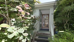 A house with a number 59 on the door, surrounded by lush greenery. - Near the Ocean/Self Check-in/Out/Wifi/High Cleaning Standards  (Victoria)