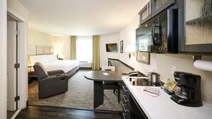 A hotel room with a bed, a desk, a coffee maker, and a microwave. - Candlewood Suites Orlando - Lake Buena Vista by IHG (Orlando)