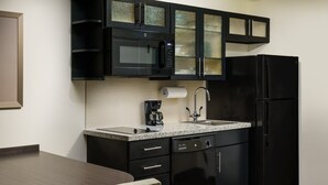 A compact kitchen with a microwave, coffee maker, sink, and dishwasher. - Candlewood Suites Orlando - Lake Buena Vista by IHG (Orlando)