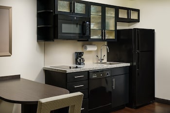 Full-size fridge, microwave, stovetop, dishwasher at Candlewood Suites Orlando - Lake Buena Vista by IHG