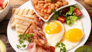 A breakfast plate with eggs, bacon, toast, beans, and a salad. - Holiday Inn Xining Hot-Spring by IHG (Xining)