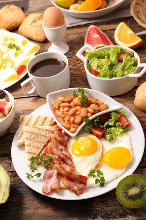 A breakfast plate with eggs, bacon, toast, beans, and a salad. - Holiday Inn Xining Hot-Spring by IHG (Xining)