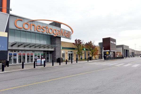 A Conestoga Mall with a modern entrance, accessible parking, and a Pickle Barrel restaurant.