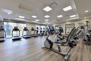 A gym with treadmills, elliptical machines, and weight equipment. - Staybridge Suites Waterloo - St. Jacobs Area by IHG (Township of Woolwich)