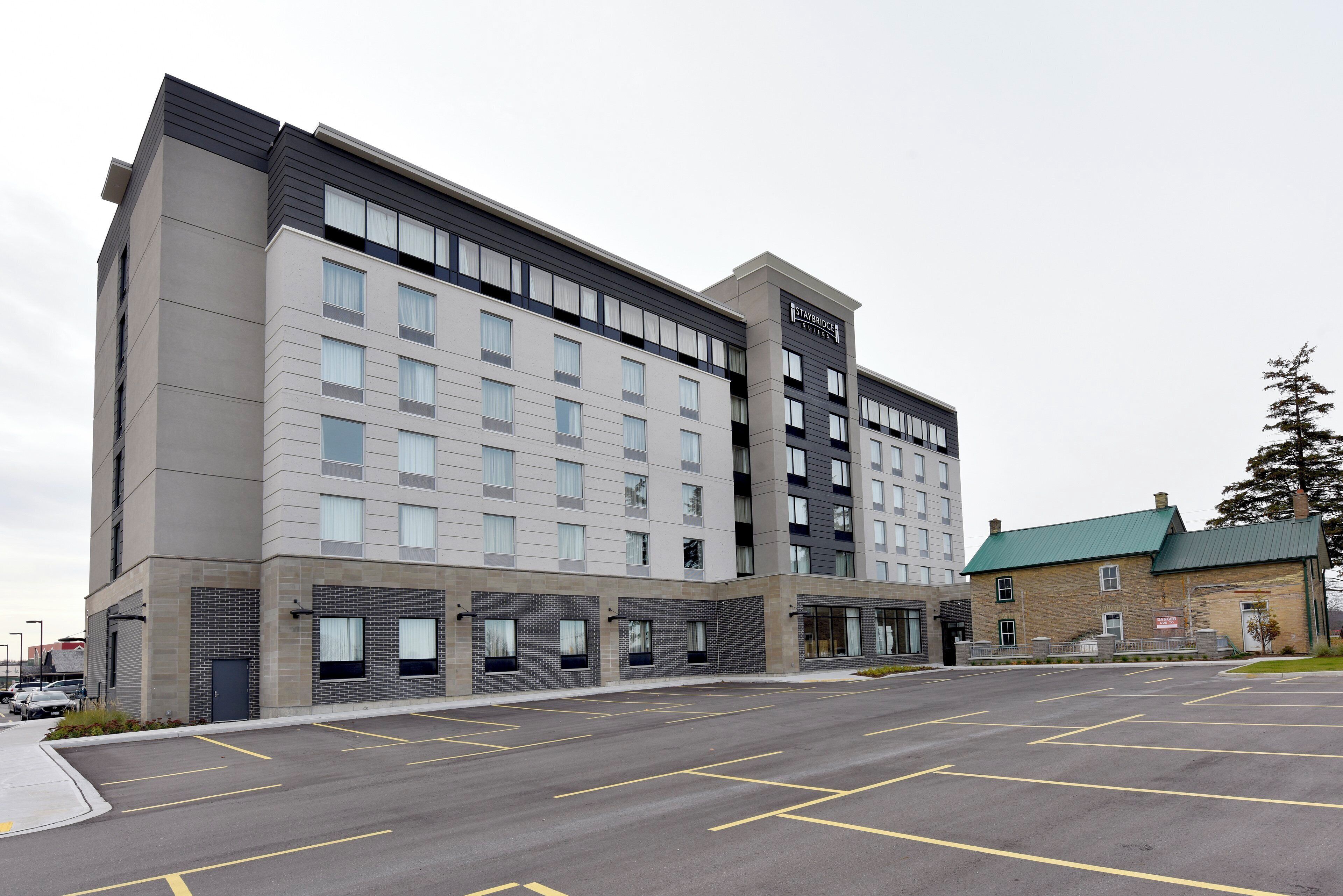 A Staybridge Suites hotel with a parking lot in front.