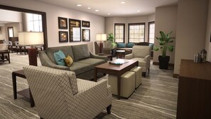 A spacious living room with a sofa, armchairs, a coffee table, and a dining area with chairs and a table. - Staybridge Suites Waterloo - St. Jacobs Area by IHG (Township of Woolwich)
