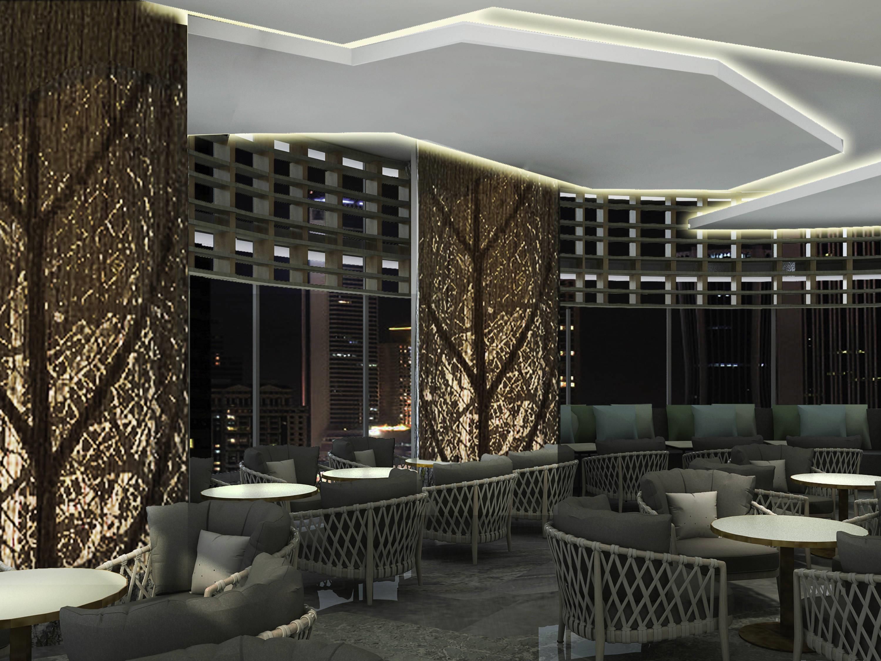 A modern outdoor seating area with wicker furniture and a geometric ceiling design.