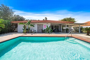 A residential property with a swimming pool, a covered patio, and a small house with a tiled roof. - Spacious 4BR Home w/ Private Pool & Backyard (Noord)